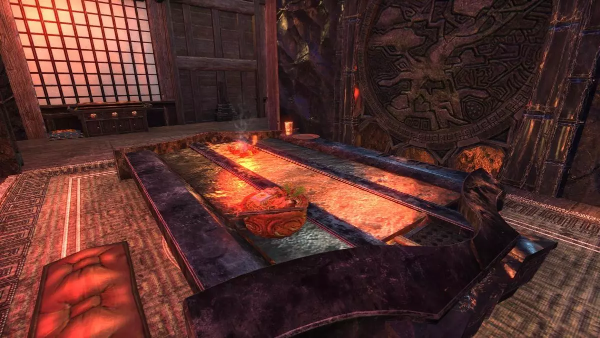 Table with a built in hibachi grill plate, ramen bowl.